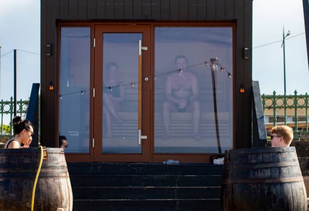 The cube sauna with whisky-barrel cold plunges outside